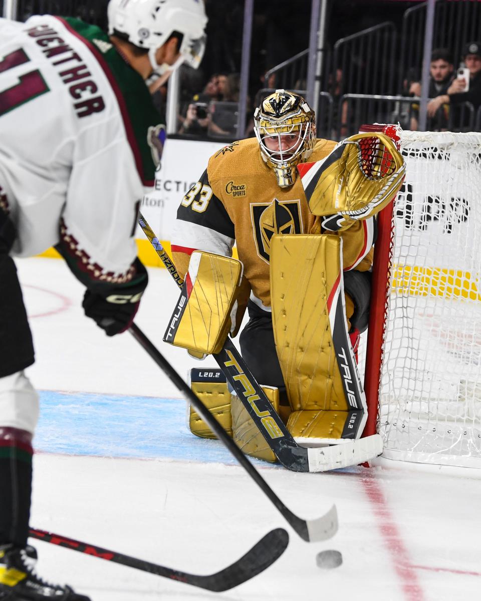 Vegas Golden Knights goaltender Adin Hill (33) watches a shot by Arizona Coyotes forward Dylan Guenther during the third period of an NHL preseason hockey game Tuesday, Oct. 4, 2022, in Las Vegas. The Vegas Golden Knights won 4-3.