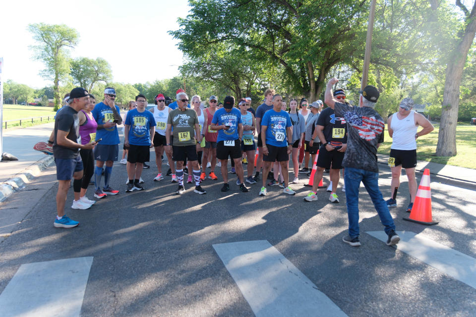 Johnny Cobb addresses a group of runners at the Chief Petty Officer Jack R. Barnes Run For the Fallen Saturday morning at Stephen F Austin Park in Amarillo.