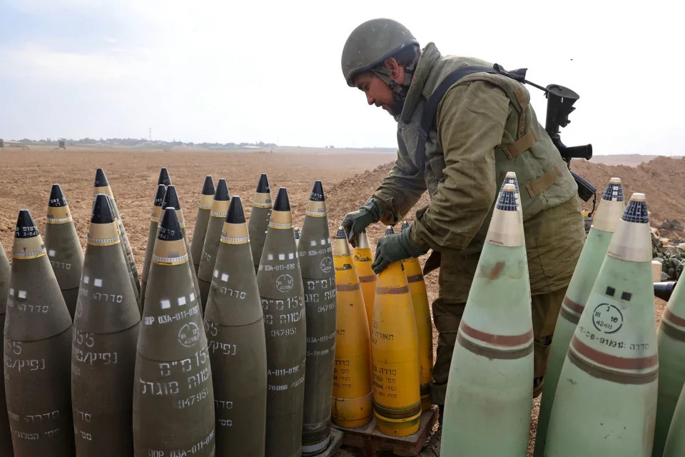 Israeli army soldier arranges artillery shells on the border with Gaza in southern Israel (Jack Guez / AFP via Getty Images)