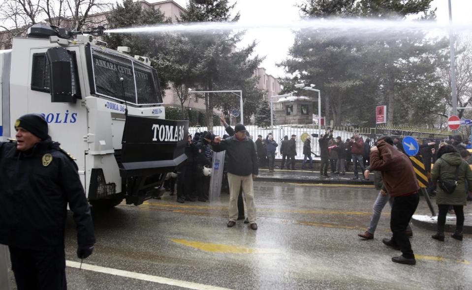 Riot police use a water cannon to disperse protesters as dozens of demonstrators gather in front of Turkey's parliament to protest proposed amendments to the country's constitution that would hand sweeping executive powers to President Recep Tayyip Erdogan's largely ceremonial presidency, in Ankara, Turkey, Monday. Jan. 9, 2017. Parliament is kicking off a debate Monday on a set of draft amendments.(AP Photo)