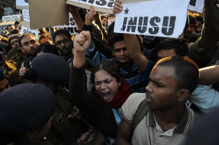 New Delhi residents hold signs and chant slogans as they protest the alleged rape of a passenger by an Uber driver working in the Indian capital on December 7, 2014