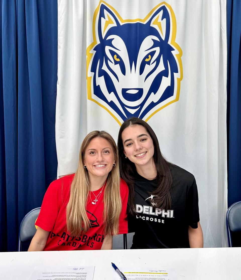 Highland girls lacrosse teammates Leah Klotz, left, and Caitlin Becker sign their National Letters of Intent during a Thursday ceremony. Klotz committed to SUNY Plattsburgh and Becker to Adelphi University.