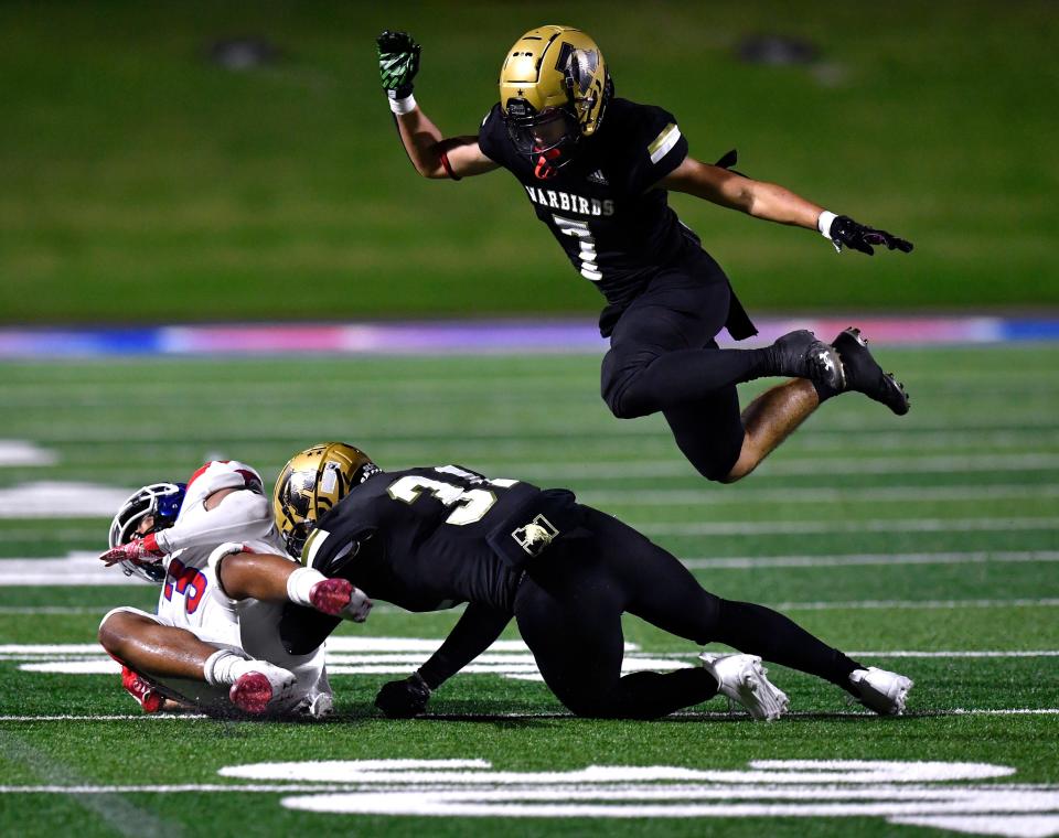 Eagles defensive back Noah Hatcher soars over the tackle between Cooper wide receiver D'Andre Ralston and Abilene High linebacker Kenneth Johnson during the annual crosstown showdown last season at Shotwell Stadium.