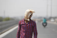 <p>A man uses a cloth to protect himself from the sun during a hot summer day in Jammu, India, May 20, 2016. The prolonged heat wave this year has already killed hundreds and destroyed crops in more than 13 states, impacting hundreds of millions of Indians. (Channi Anand/AP) </p>