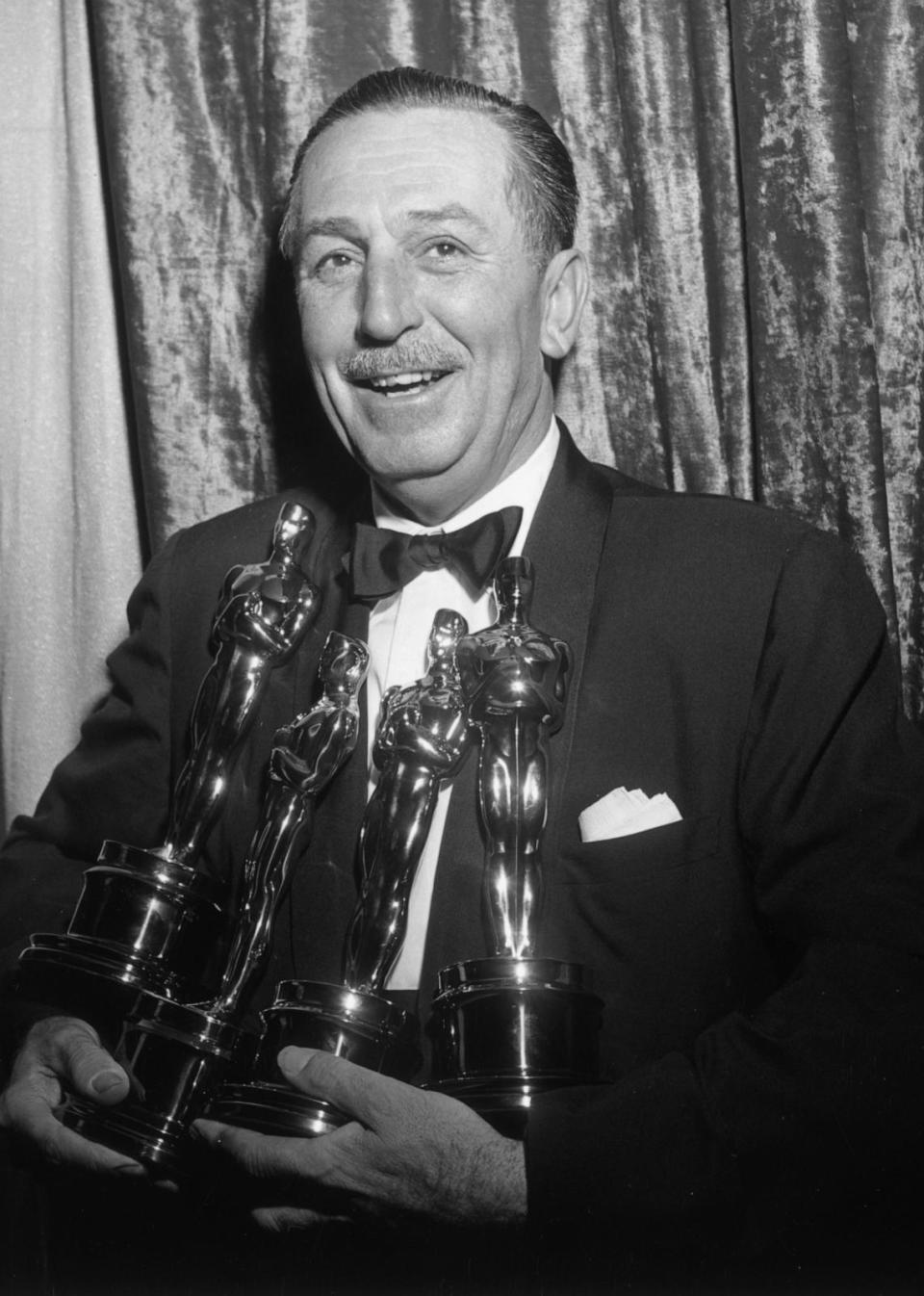 PHOTO: American animator and producer Walt Disney smiles and holds his four Oscars backstage at the Academy Awards, Los Angeles, March 25, 1954. (Hulton Archive/Getty Images, FILE)