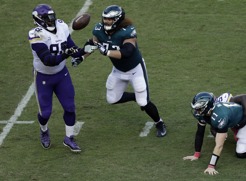 Minnesota Vikings' Linval Joseph (98) catches a fumble by Philadelphia Eagles' Carson Wentz (11) as Isaac Seumalo (73) looks on during the first half of an NFL football game, Sunday, Oct. 7, 2018, in Philadelphia. (AP Photo/Michael Perez)