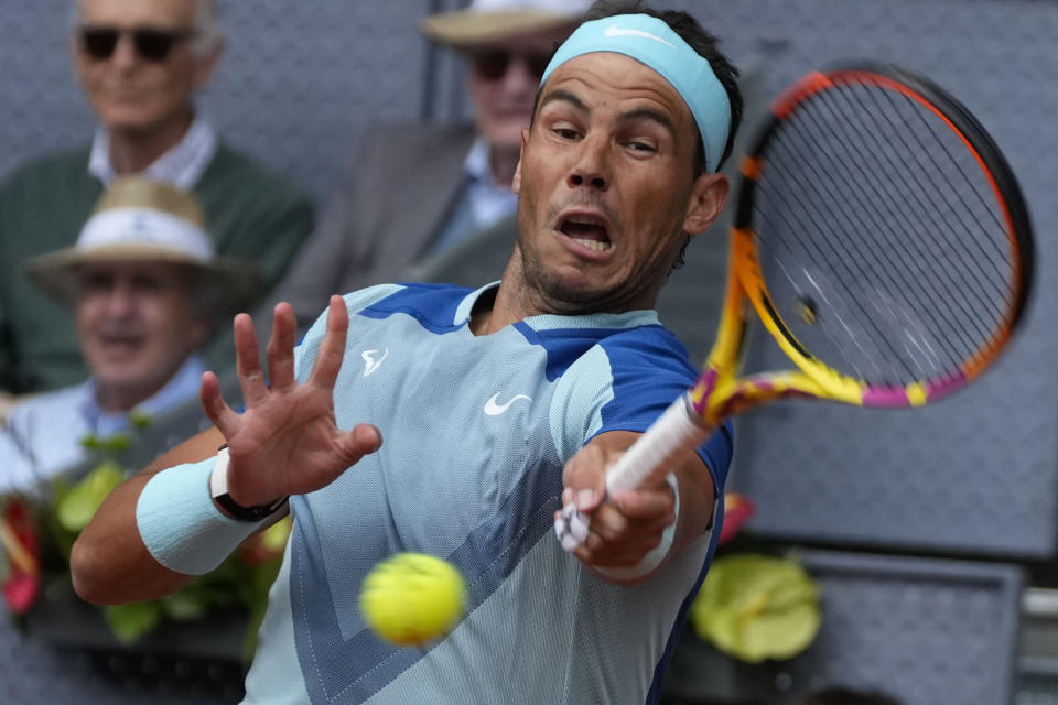 Rafael Nadal of Spain returns the ball to Miomir Kecmanovic of Serbia during their match at the Mutua Madrid Open tennis tournament in Madrid, Spain, Wednesday, May 4, 2022. (AP Photo/Paul White)