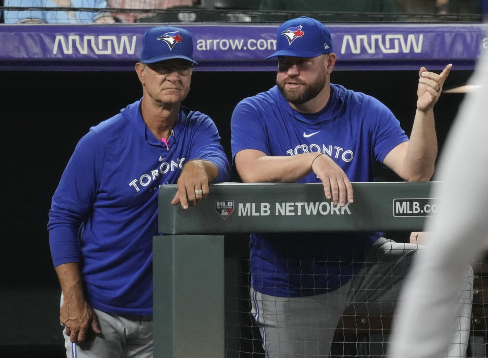 Toronto Blue Jays bench coach Don Mattingly, left, confers with manager John Schneider in the sixth inning of a baseball game Friday, Sept. 1, 2023, in Denver. (AP Photo/David Zalubowski)