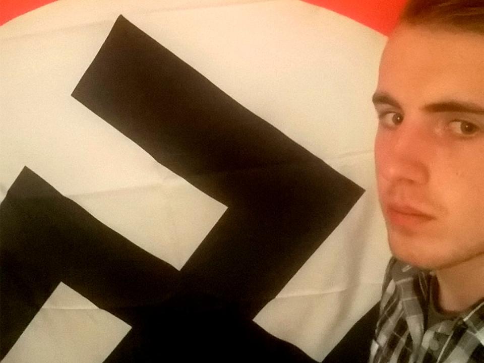 Ethan Stables poses next to a swastika, before his planned attack (SWNS.com)