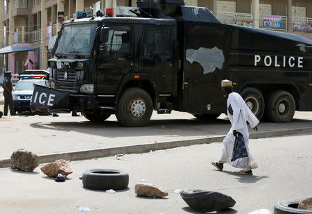 A man walks towards a police vehicle stationed outside the INEC office, as the country awaits the result of the presidential election, in Kano, Nigeria February 25, 2019. REUTERS/Afolabi Sotunde