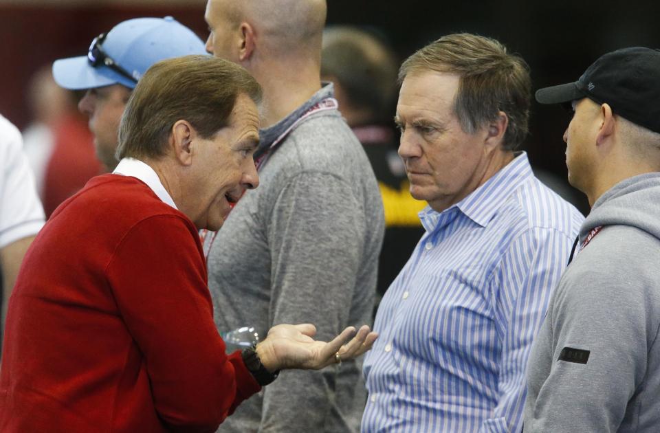 Bill Belichick (middle) and Alabama head coach Nick Saban share some thoughts at the Crimson Tide's pro day. (AP) 