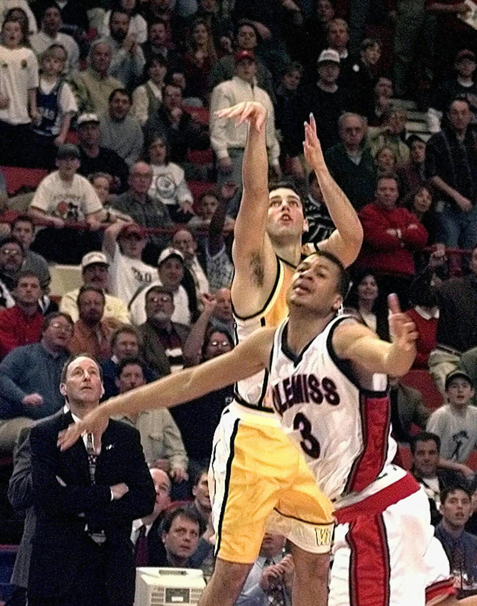 FILE - In this March 13, 1998, file photo, Valparaiso's Bryce Drew (20) follows through with his game-winning three-point shot at the buzzer over Mississippi's Jason Flanigan (3) in their first round game of the NCAA Midwest Regional in Oklahoma City. At left is Valparaiso coach Homer Drew watching his son's shot. (AP Photo/J.Pat Carter, File)