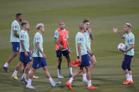 Brazil's Antony, right, talks with teammates during a training session at the Grand Hamad stadium in Doha, Qatar, Tuesday, Nov. 29, 2022. Brazil will face Cameroon in a group G World Cup soccer match on Dec. 2. (AP Photo/Andre Penner)