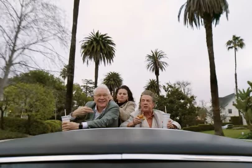 Steve Martin, Martin Short and Selena Gomez chatting with their heads out the roof of a car