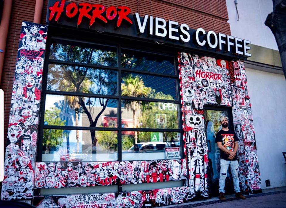 Taunton-born artist Phill Bourque is seen here in front of mural art he painted for Horror Vibes Coffee in North Hollywood, California.