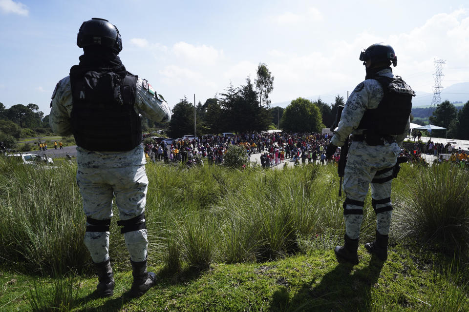 FILE - Escorted by Mexican National Guards, locals gather to plant pine saplings in the San Miguel Topilejo borough of Mexico City, Aug. 13, 2023. Illegal logging is particularly acute in San Miguel Topilejo, which, because it has forests and is crossed by highways, makes it an attractive place for gangs to cut logs and move them to sawmills. (AP Photo/Marco Ugarte, File)