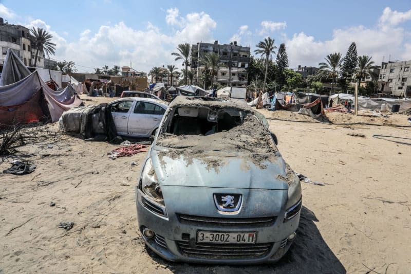 View of a damaged vehicle at the site of the Israeli bombing of the Al-Mawasi camp the previous day, amid the ongoing conflict between Israel and Hamas.  Abed Rahim Khatib/dpa