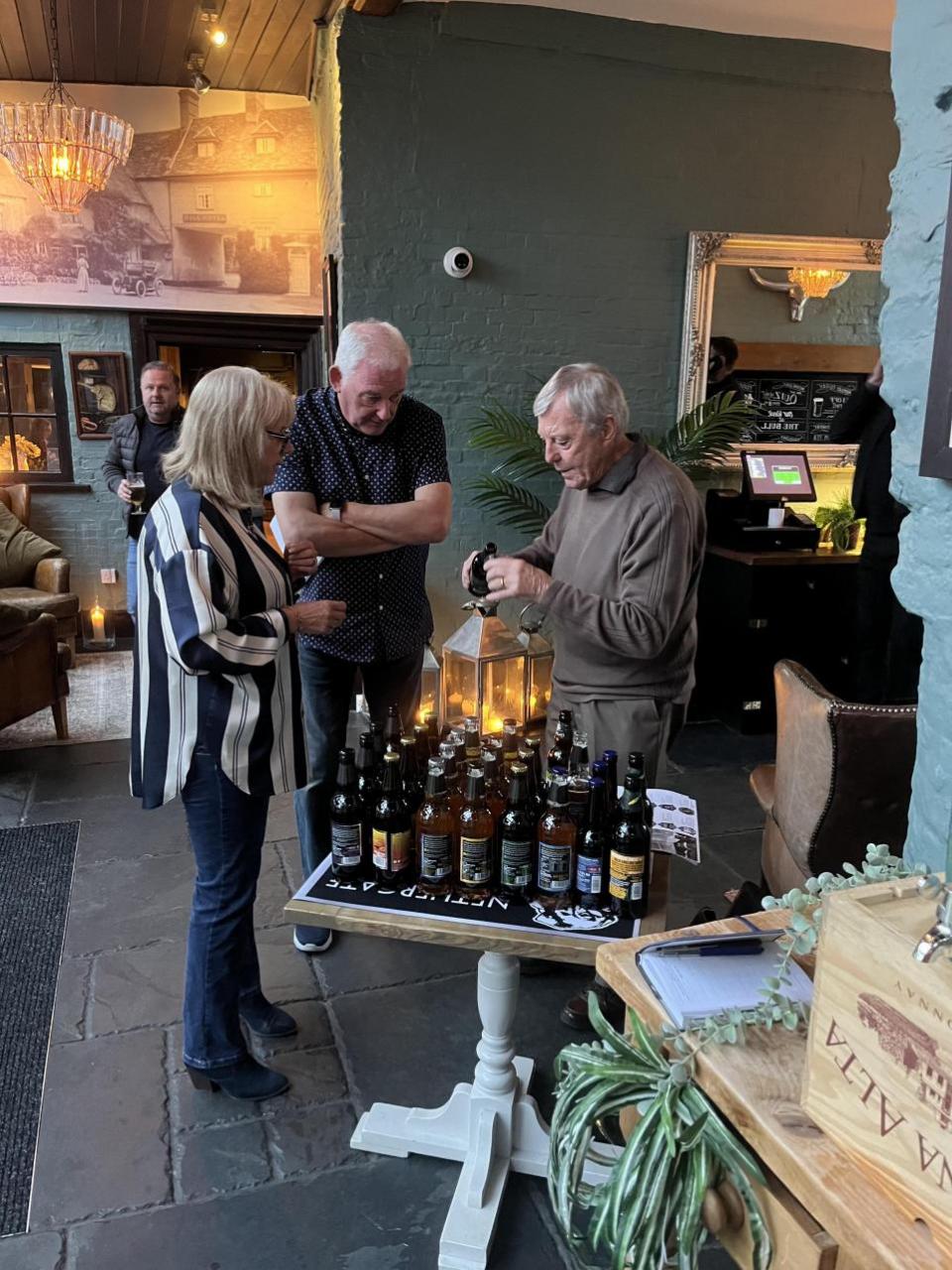 East Anglian Daily Times: John Bennett from Nethergate Brewery sharing samples to guests 