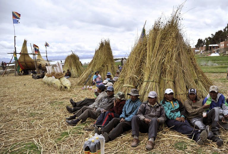 Workers take a break from the construction of a bulrush boat or "Thunupa" on Suriqui island in Lake Titicaca, Bolivia, on December 2, 2012. The Limachis and other Aymara native residents of Suriqui Island have built 22 trans-oceanic reed vessels over the past decades, and if funding comes through, will build a ship they hope will sail from New York to Spain in 2014