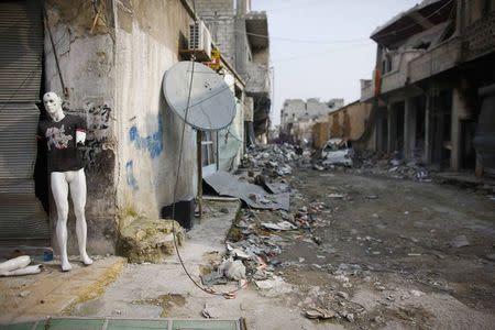 A mannequin is pictured at a damaged building in the northern Syrian town of Kobani January 28, 2015. REUTERS/Osman Orsal