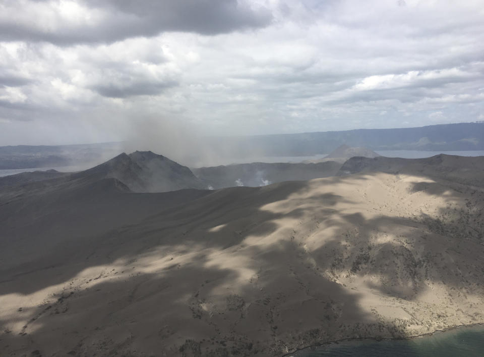 In this Jan. 21, 2020, photo provided by the Philippines Office of Civil Defense, Taal volcano emits small amounts of ash in Batangas province, southern Philippines. The Philippine government will no longer allow people to live on the crater-studded island that's home to the volcano. (Philippines Office of Civil Defense via AP)