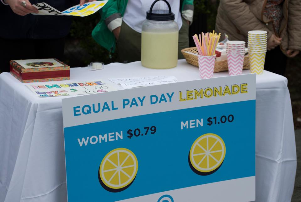 A lemonade stand advertising "equal pay day lemonade"