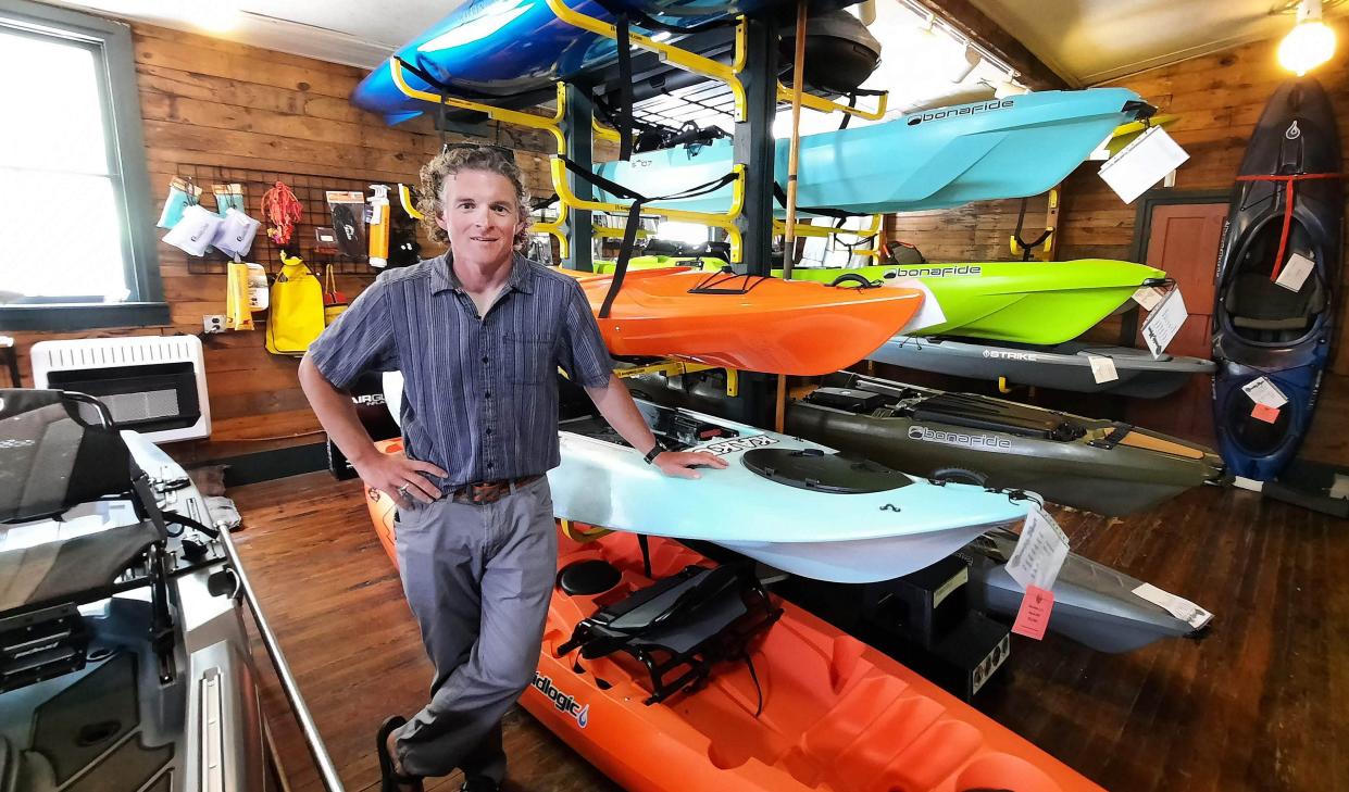 Devin Winand of Shank's Mare Outfitters in Wrightsville stands May 12, 2022, with a variety of kayaking options to improve your boating experience.