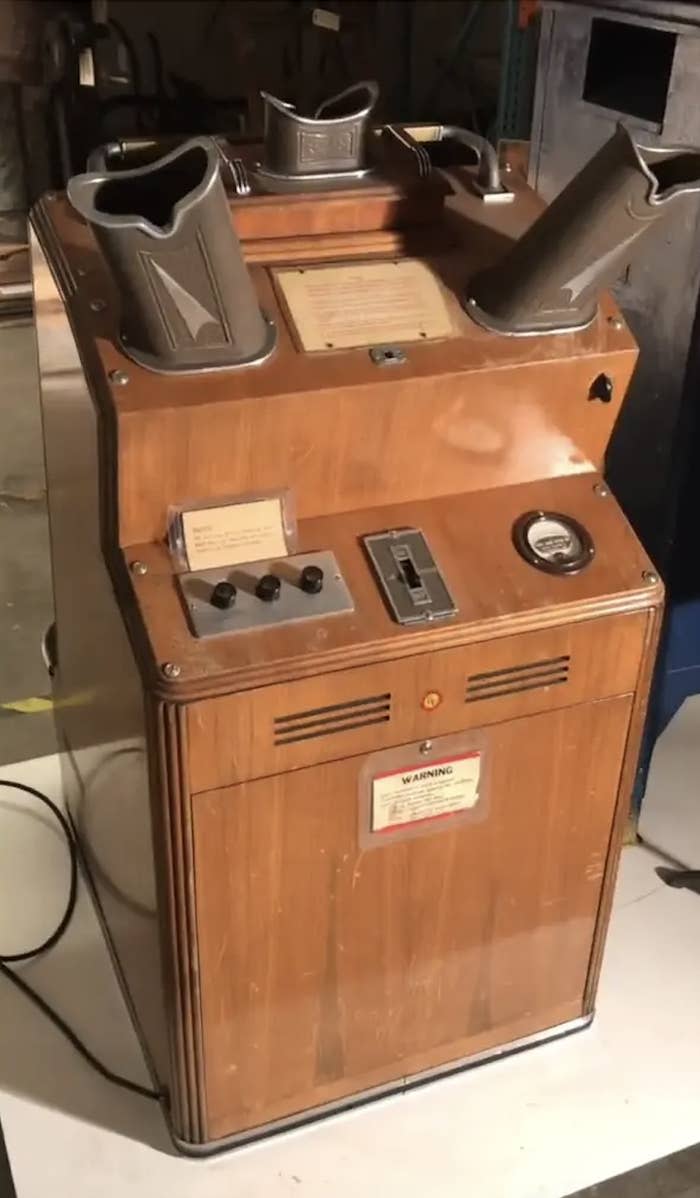 Vintage shoe shining machine with various control knobs and footrests