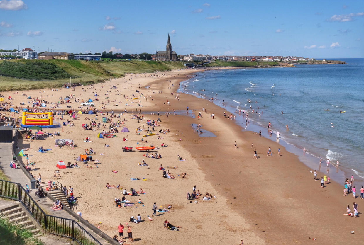 A general view of beachgoers on Tynemouth Longsands beach. (PA)