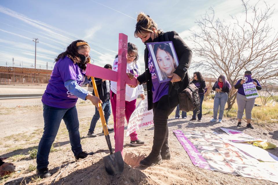 Women who have lost their daughters to femicides put a cross on the bank of the Rio Grande as part of a march calling for justice for women on International Women's Day on Wednesday, March 8, 2023, for women on both sides of the border in Juárez, Mexico.