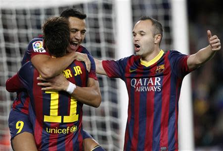 Barcelona's Alexis Sanchez (L, facing camera) celebrates a goal against Espanyol with teammates Neymar and Andres Iniesta (R) during their Spanish First division soccer league match at Camp Nou stadium in Barcelona, November 1, 2013. REUTERS/Albert Gea