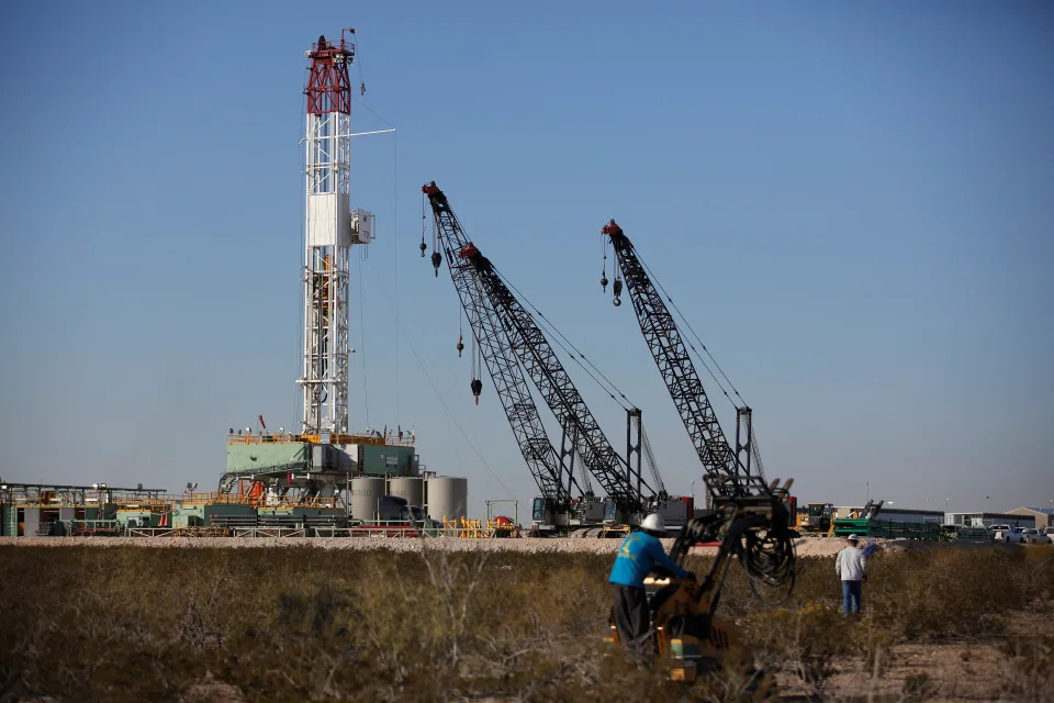 An oil worker drives a forklift truck towards a drill rig after placing some ground monitoring equipment in the vicinity of the underground horizontal drill in Loving County, Texas, U.S. November 22, 2019. Picture taken November 22, 2019. REUTERS/Angus Mordant. Oil Prices drop lower.