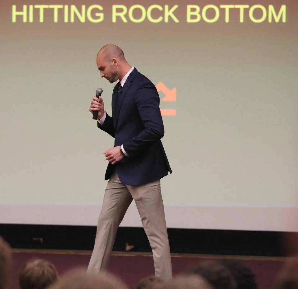 Luke Timm, a 2016 graduate from Our Lady of Lourdes High School, talks about his struggles with drug addiction during an assembly at the high school on May 10, 2023. 