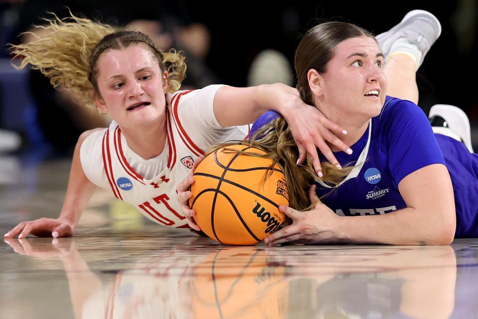 First round: Utah's Matyson Wilke (left) and South Dakota State's Paige Meyer dive for the ball.