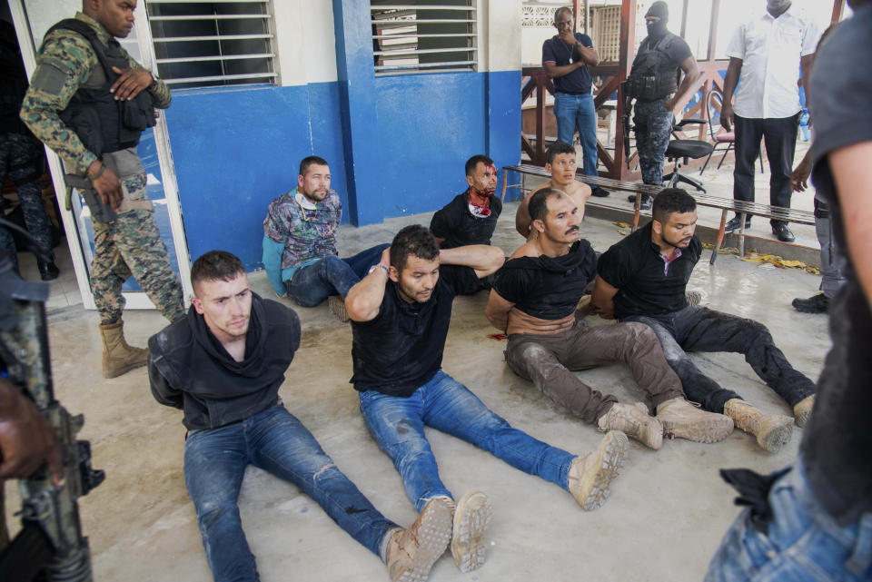 Police guard detained suspects in the assassination of Haiti's President Jovenel Moise at the General Direction of the police in Port-au-Prince, Haiti, Thursday, July 8, 2021. Moïse was assassinated in an attack on his private residence early Wednesday. (AP Photo/Jean Marc Hervé Abélard)