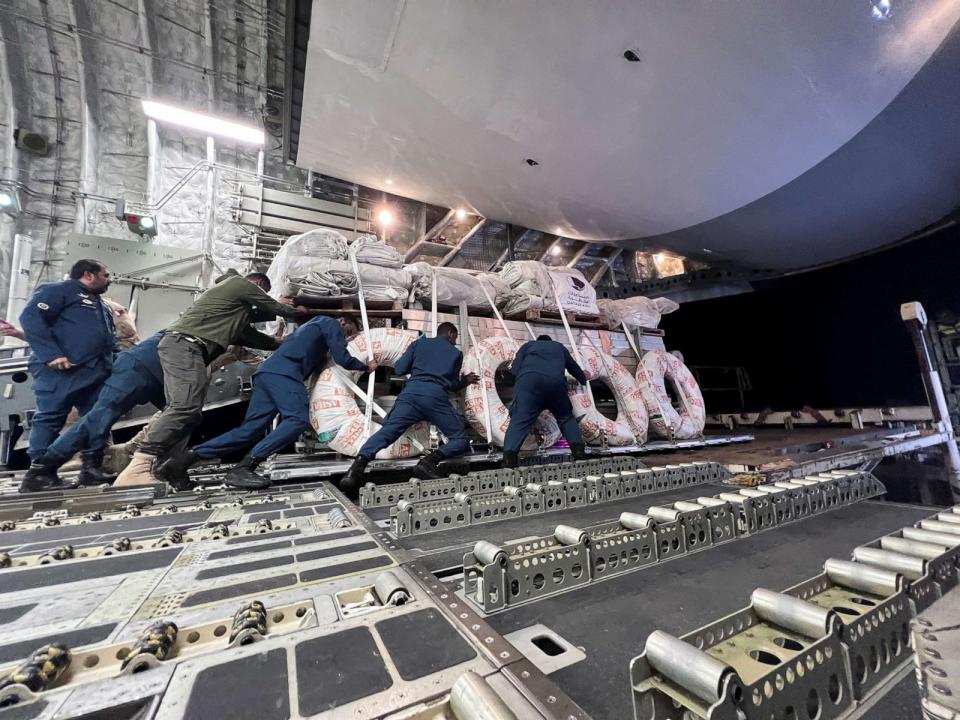 PHOTO: Workers unload relief items from a military cargo aircraft arriving from Qatar to provide support on the ground, following a powerful storm and heavy rainfall in the country, at Benina International Airport, in Benghazi, Libya, on Sept. 13, 2023. (Imad Creidi/Reuters)