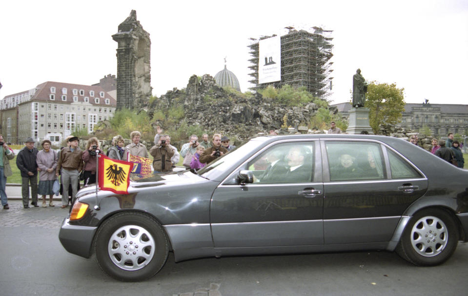 FILE - The car carrying Britain's Queen Elizabeth II drives past ruins of the Frauenkirche (Church of Our Lady) in Dresden, East Germany, on her way to a reconciliation service held in another Dresden church, on Oct. 22, 1992. Records showed that the British embassy had concerns about possible protests if the queen visited Dresden during her trip in 1992. In the end she did attend a church service in the city that was flattened by Allied bombers during the war and was largely welcomed by locals, Der Spiegel reported Monday, March 27, 2023. (AP Photo/Dennis Paquin, File)