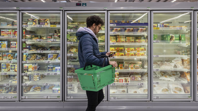 man shopping in freezer aisle