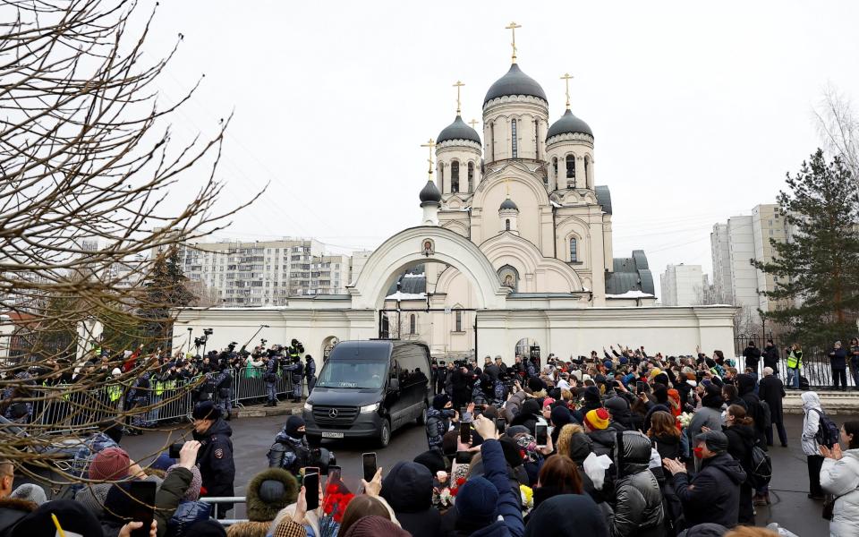 A hearse reportedly carrying the body of Russian opposition politician Alexei Navalny is parked outside the Soothe My Sorrows church