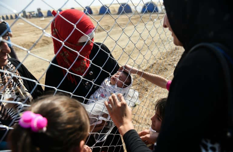 Newly displaced Iraqis who fled from the northern city of Mosul are reunited with their relatives in a refugee camp in the Khazir area, near the Kurdish checkpoint of Aksi Kalak