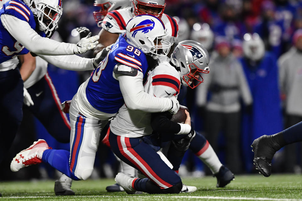 New England Patriots quarterback Mac Jones (10) is sacked by Buffalo Bills defensive tackle Star Lotulelei (98) during the first half of an NFL wild-card playoff football game, Saturday, Jan. 15, 2022, in Orchard Park, N.Y. (AP Photo/Adrian Kraus)