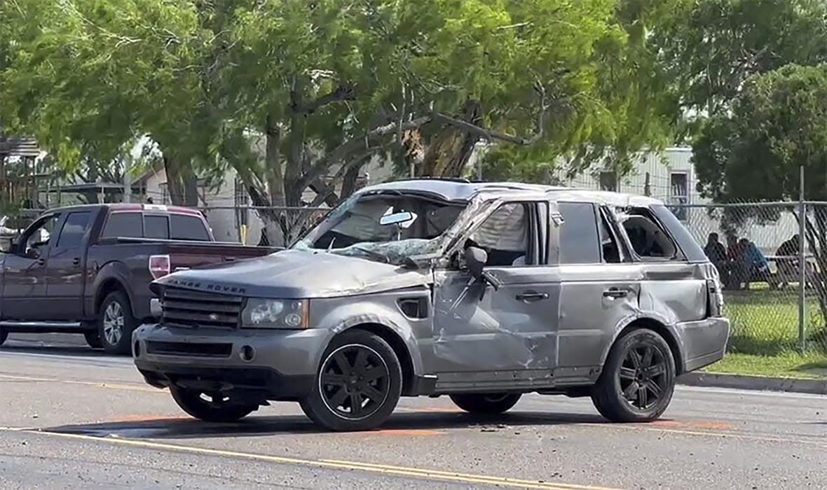 A damaged vehicle sits at the site of a deadly collision near a bus stop in Brownsville, Texas, on Sunday, May 7, 2023. (Brian Svendsen/NewsNation/KVEO-TV via AP)