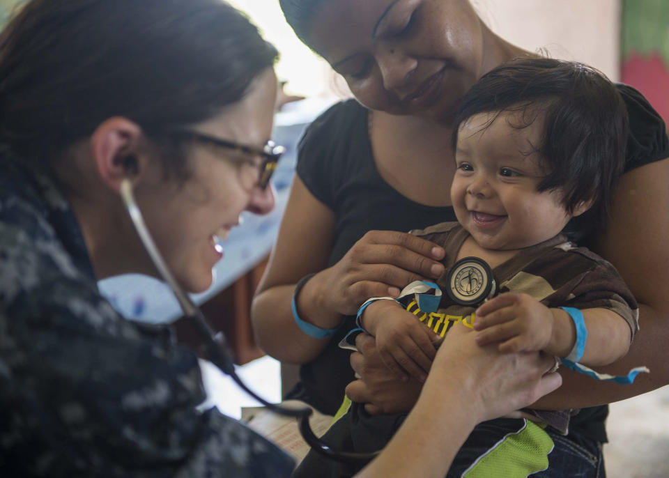 Lt Cmdr. Melissa Buryl, from Canton, Ohio, a pediatrician stationed at Naval Medical Center Portsmouth, Virginia, checks a child's vital signs at the Hattieville Government School in Hattieville, Belize on April 17, 2015. 