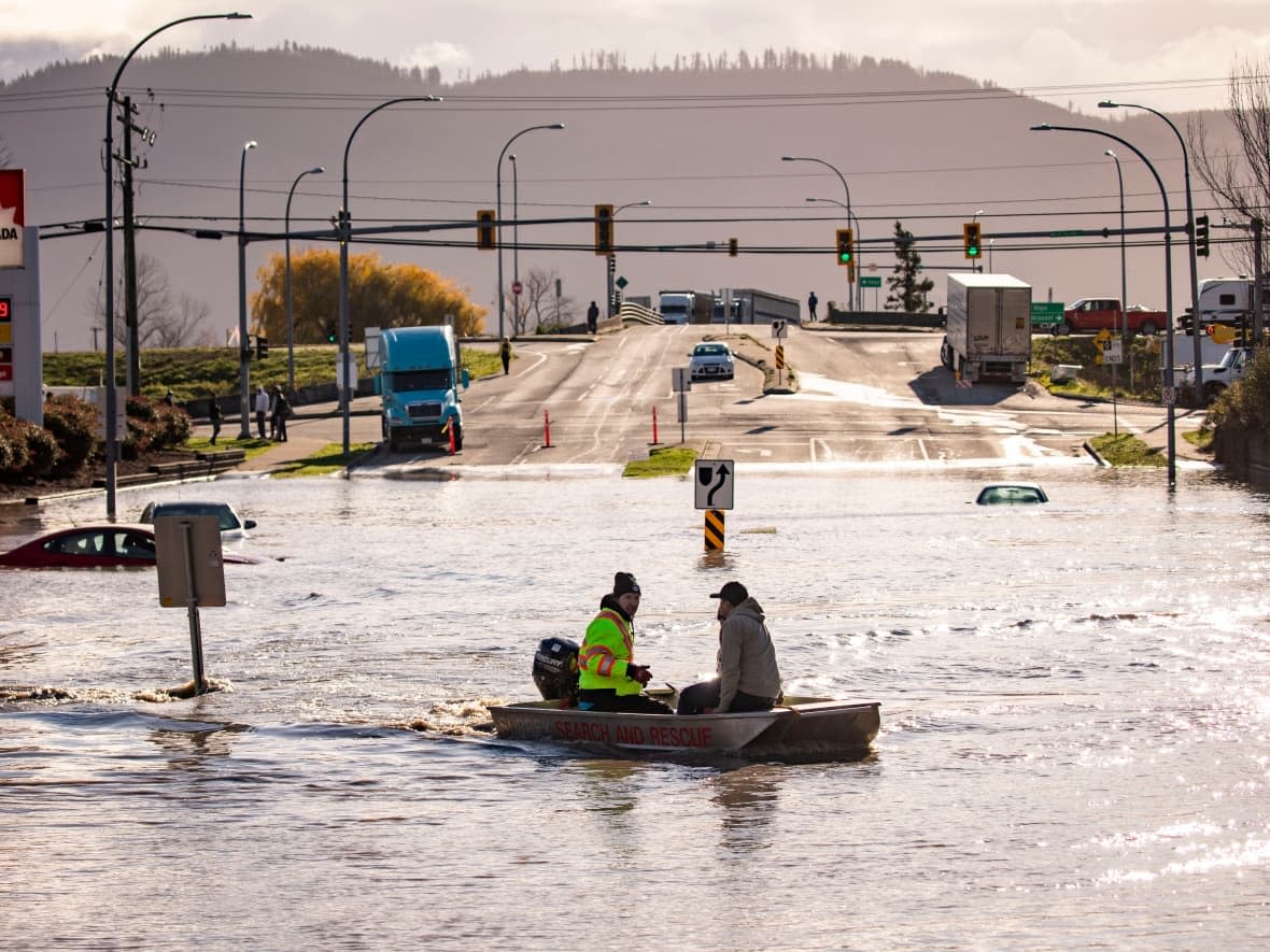 People are transported on a boat after being rescued from an area that was cut off due to flooding in Abbotsford, B.C., on Tuesday.  (Ben Nelms/CBC - image credit)