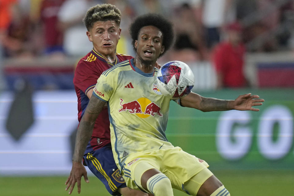 Real Salt Lake midfielder Diego Luna, rear, defends against New York Red Bulls defender Kyle Duncan, right, during the second half of an MLS soccer match Saturday, July 15, 2023, in Sandy, Utah. (AP Photo/Rick Bowmer)