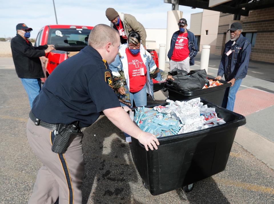 Volunteers and Lubbock County Detention Center officers get ready to bring bins of candy to inmates Christmas afternoon. The visit was intended to carry on a Christmas tradition started by T.J. Patterson, Sr., through his daughter, Councilwoman Shelia Patterson Harris Sunday, Dec. 25, 2022. T.J. Patterson, Sr. passed away Sept. 21, 2022.