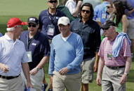 Former professional hockey player Wayne Gretzky, center, walks along the second fairway during the second round of the Masters golf tournament Friday, April 11, 2014, in Augusta, Ga. (AP Photo/David J. Phillip)