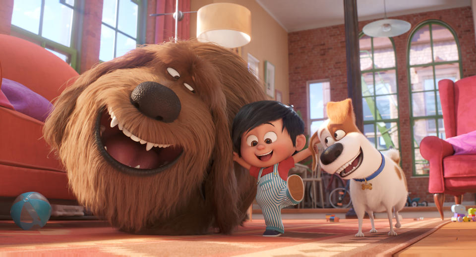 This image released by Universal Pictures shows, from left, Duke, voiced by Eric Stonestreet, Liam, voiced by Henry Lynch and Max, voiced by Patton Oswalt in a scene from "The Secret Life of Pets 2." (Illumination Entertainment/Universal Pictures via AP)