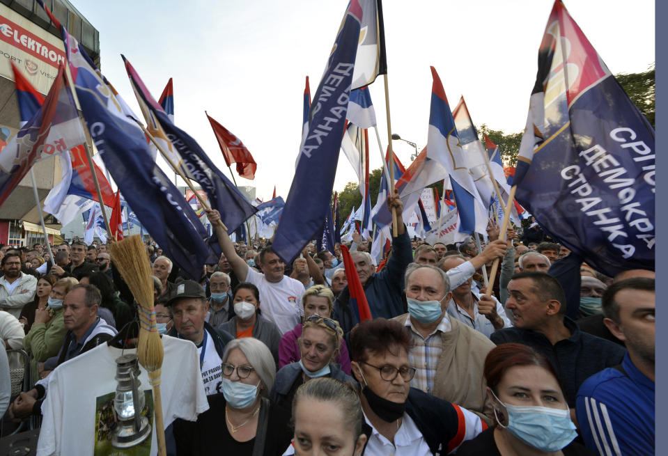 People gather for a protest against the government in Banja Luka, in Serb-dominated part of Bosnia, Saturday, Oct. 2, 2021. Several thousand people have rallied against the government in Serb-dominated part of Bosnia. The protesters on Saturday accused the ruling party of nationalist leader Milorad Dodik of crime and corruption and called for its ouster. (AP Photo/Radivoje Pavicic)