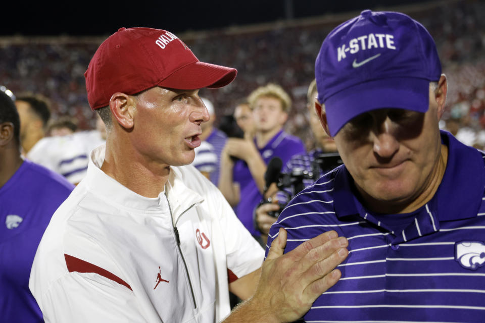 Oklahoma coach Brent Venables, left, talks to Kansas State coach Chris Klieman after an NCAA college football game Saturday, Sept. 24, 2022, in Norman, Okla. (AP Photo/Nate Billings)